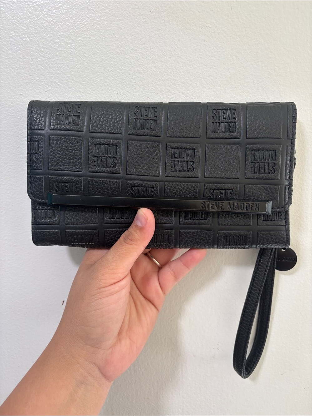 Steve Madden Black Embossed Logo Wristlet Clutch with Bar Accent